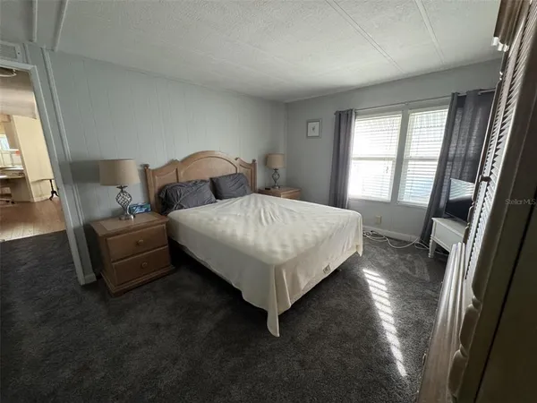 a bed sitting in a bedroom next to a window