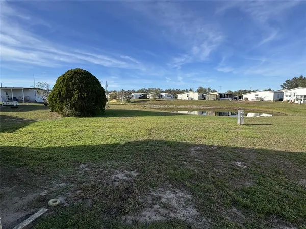 a view of a field with an ocean view