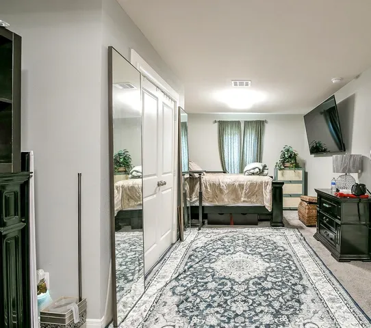 a bedroom with a bed and a couch