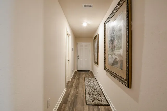 an entryway with wooden floor and staircase