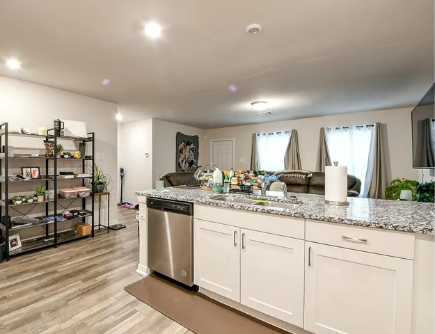 a kitchen with stainless steel appliances granite countertop a sink and cabinets