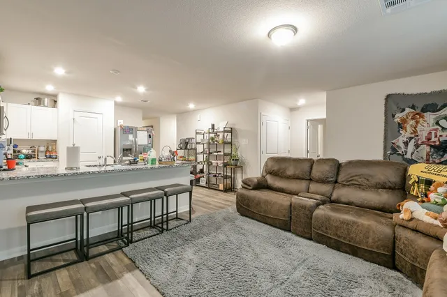 a living room with furniture with kitchen view