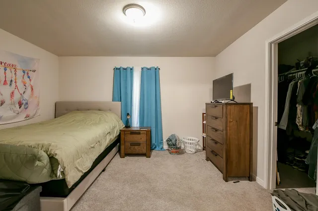 a bedroom with a bed and a television