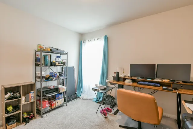 a view of a workspace with furniture