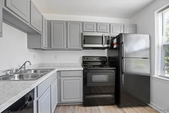 a kitchen with a sink stove and refrigerator
