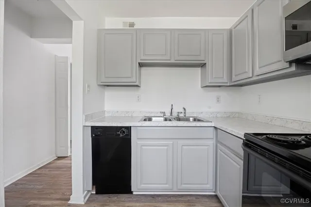 a kitchen with stainless steel appliances granite countertop a sink and a stove