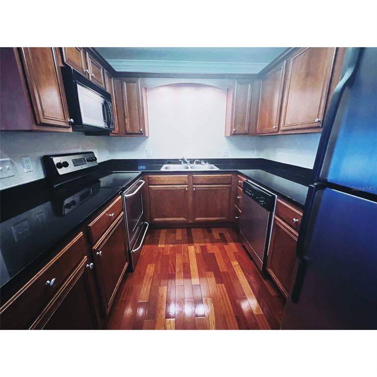 4876 South Conway Road, Unit 94 Orlando, FL 32812 - Photo 11 of 13 a kitchen with sink and cabinets