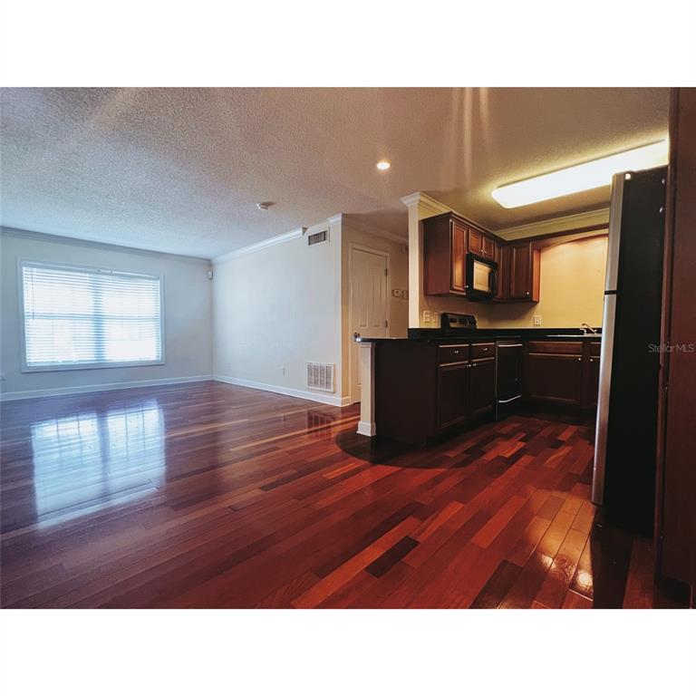 4876 South Conway Road, Unit 94 Orlando, FL 32812 - Photo 10 of 13 a open kitchen with sink and cabinets