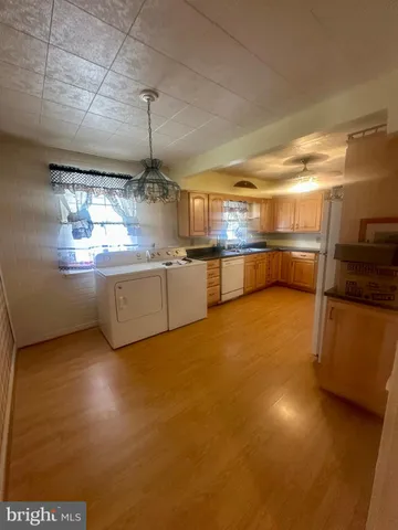 a kitchen with stainless steel appliances granite countertop a sink and cabinets