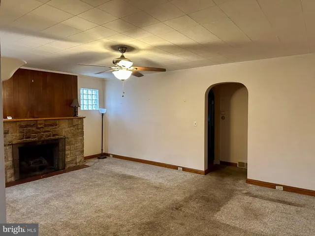 an empty room with windows and hallway