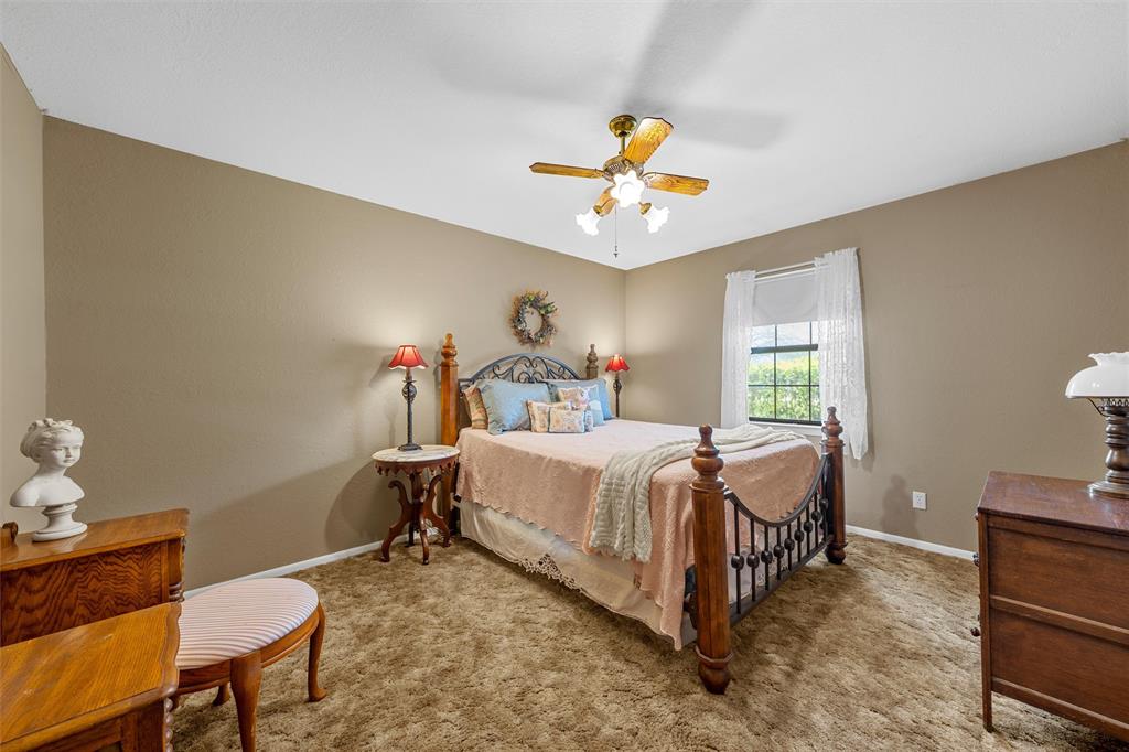 117 North 9th Street Lott, TX 76656 - Photo 14 of 28 Bedroom featuring light carpet and ceiling fan