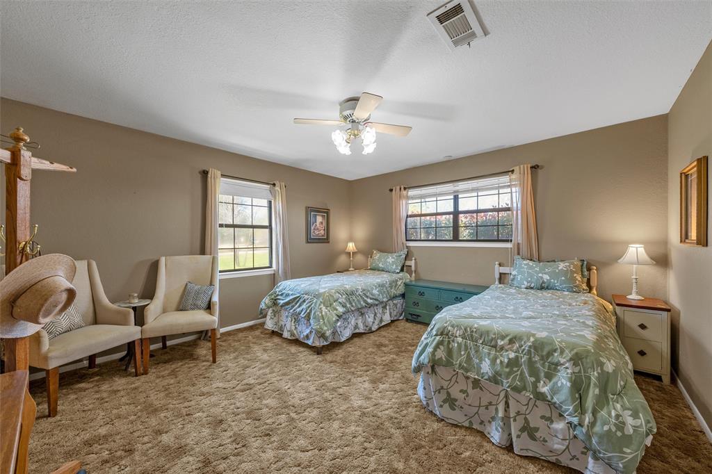 117 North 9th Street Lott, TX 76656 - Photo 16 of 28 Bedroom with carpet, a ceiling fan, and a textured ceiling