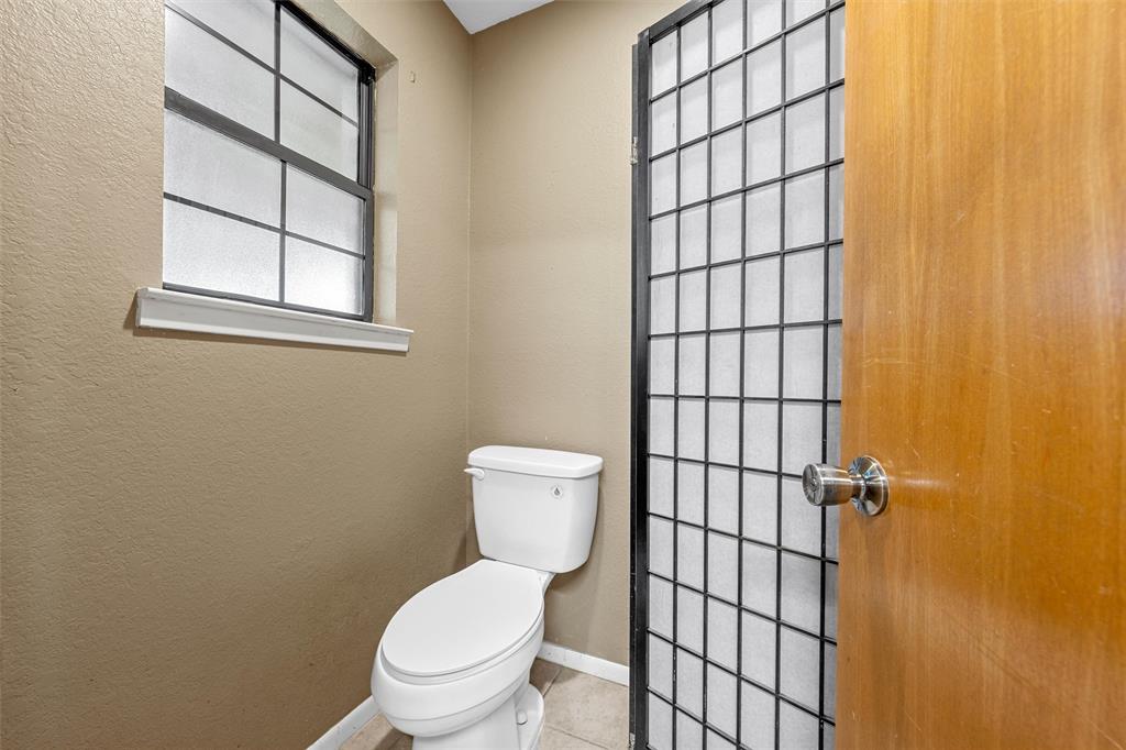 117 North 9th Street Lott, TX 76656 - Photo 18 of 28 Bathroom with a shower and a textured wall