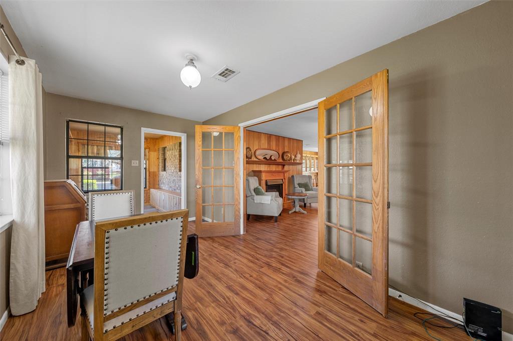 117 North 9th Street Lott, TX 76656 - Photo 8 of 28 Office space featuring french doors, a fireplace, and wood finished floors
