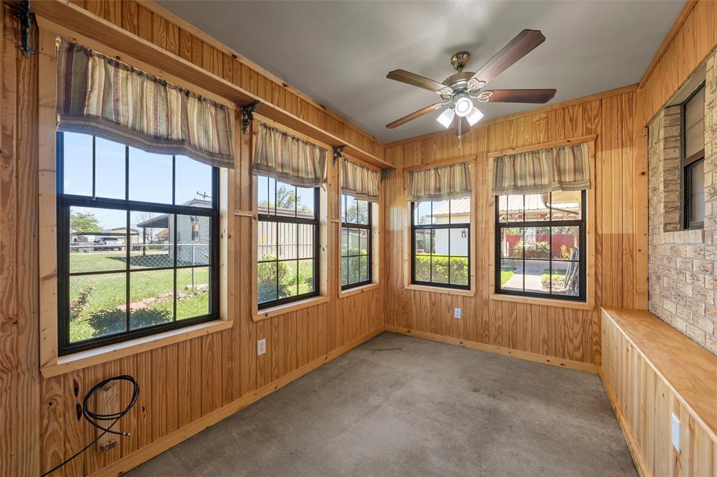 117 North 9th Street Lott, TX 76656 - Photo 10 of 28 Unfurnished sunroom with wooden walls