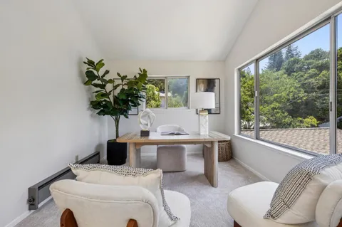 a bedroom with a bed and a potted plant