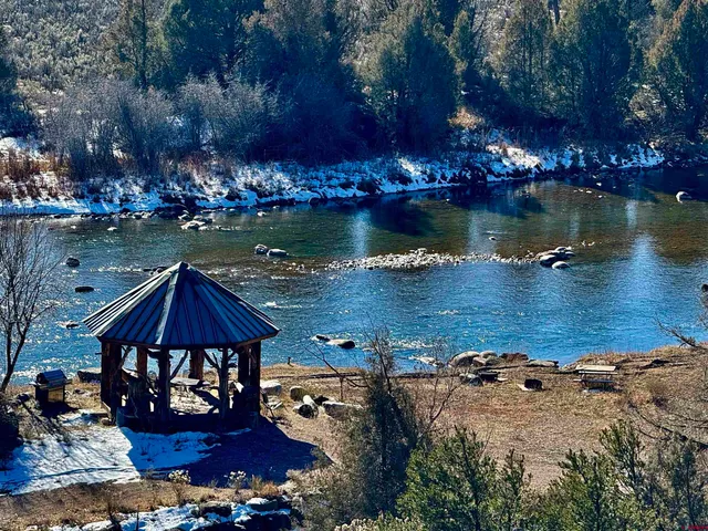 a view of a lake with a house in the background