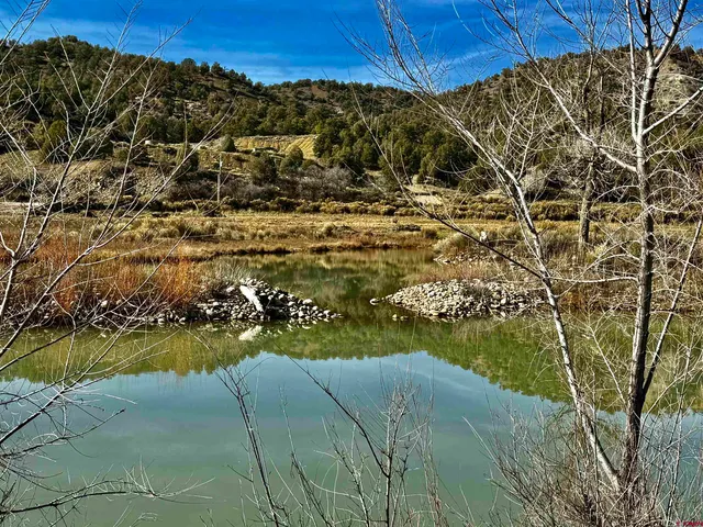 a view of water heater room with wooden floor