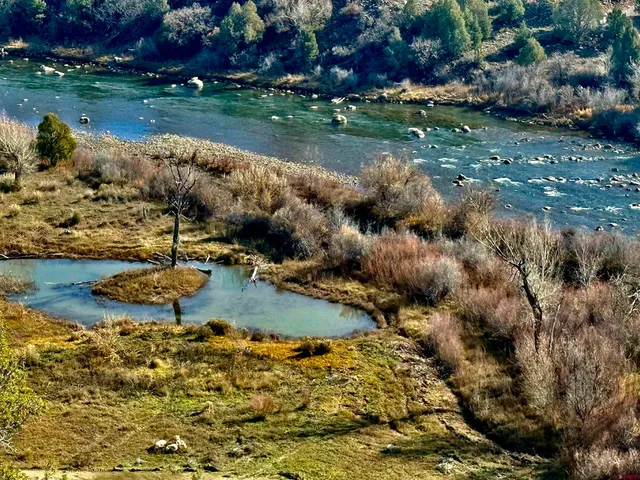a view of a lake with lawn chairs