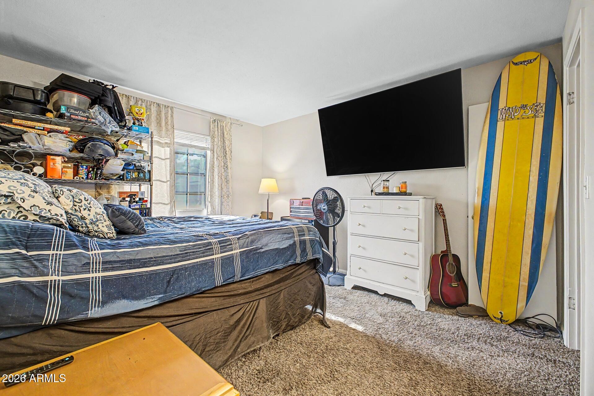 533 West Guadalupe Road, Unit 1104 Mesa, AZ 85210 - Photo 5 of 20 a bedroom with a bed and a flat tv screen