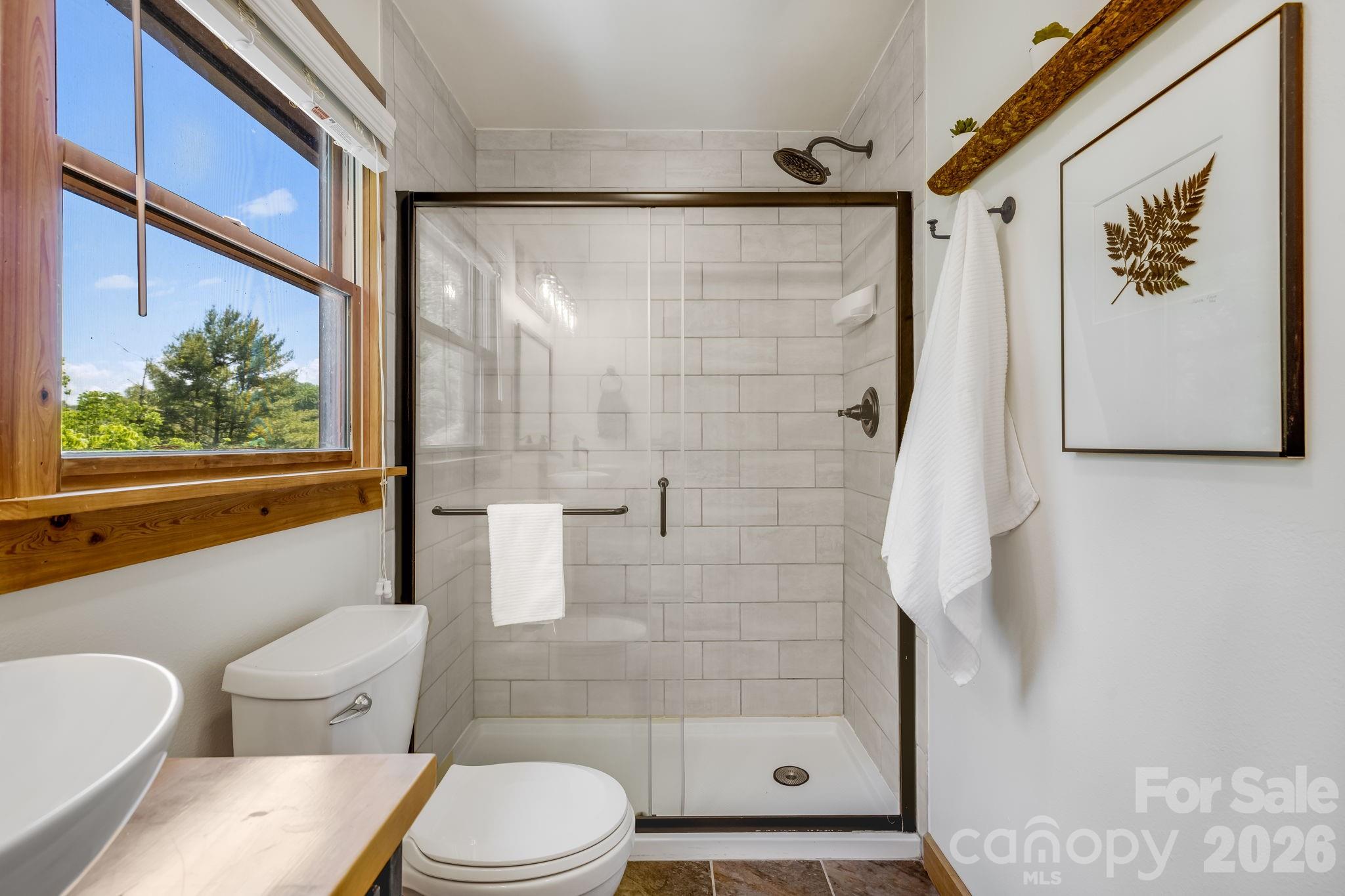 694 Boulder Road Marshall, NC 28753 - Photo 29 of 44 a bathroom with a toilet and a shower
