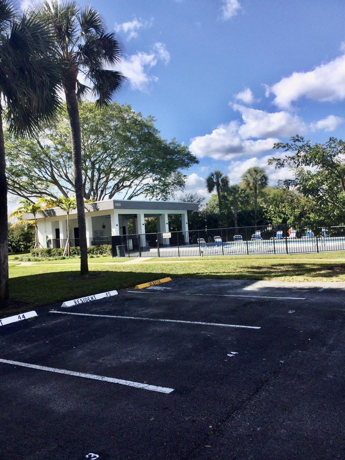 9233 Southwest 8th Street, Unit 110 Boca Raton, FL 33428 - Photo 13 of 14 a view of swimming pool is middle in the middle of a garden