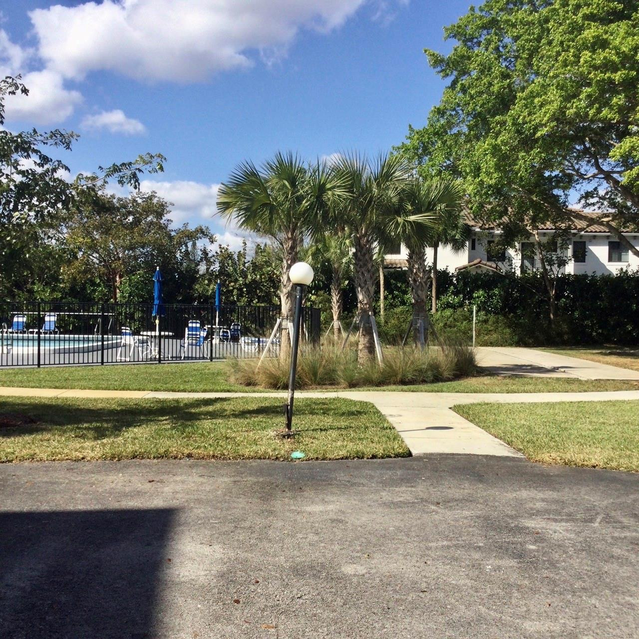 9233 Southwest 8th Street, Unit 110 Boca Raton, FL 33428 - Photo 14 of 14 a view of swimming pool with a yard