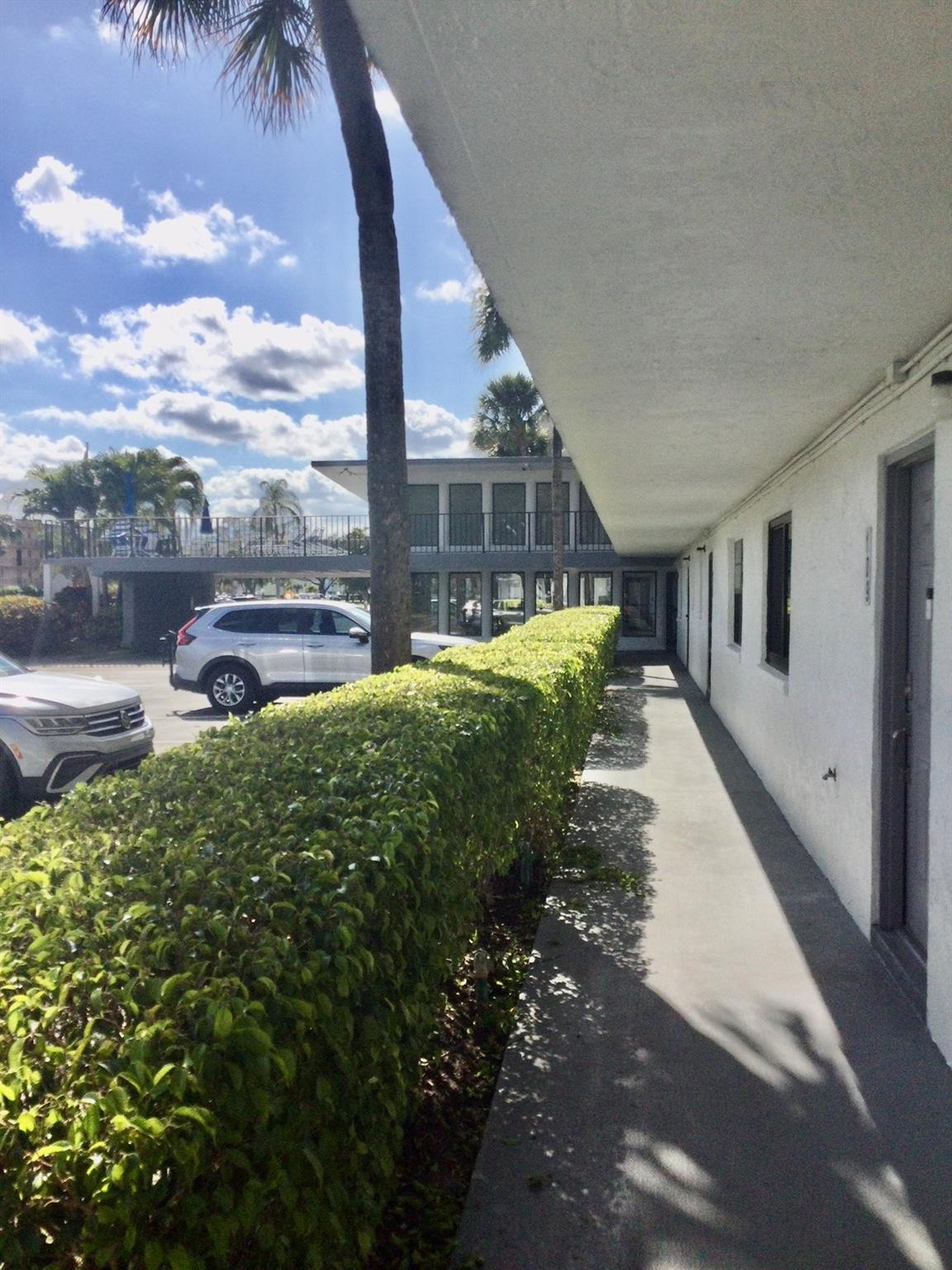 9233 Southwest 8th Street, Unit 110 Boca Raton, FL 33428 - Photo 2 of 14 a view of a house with a yard