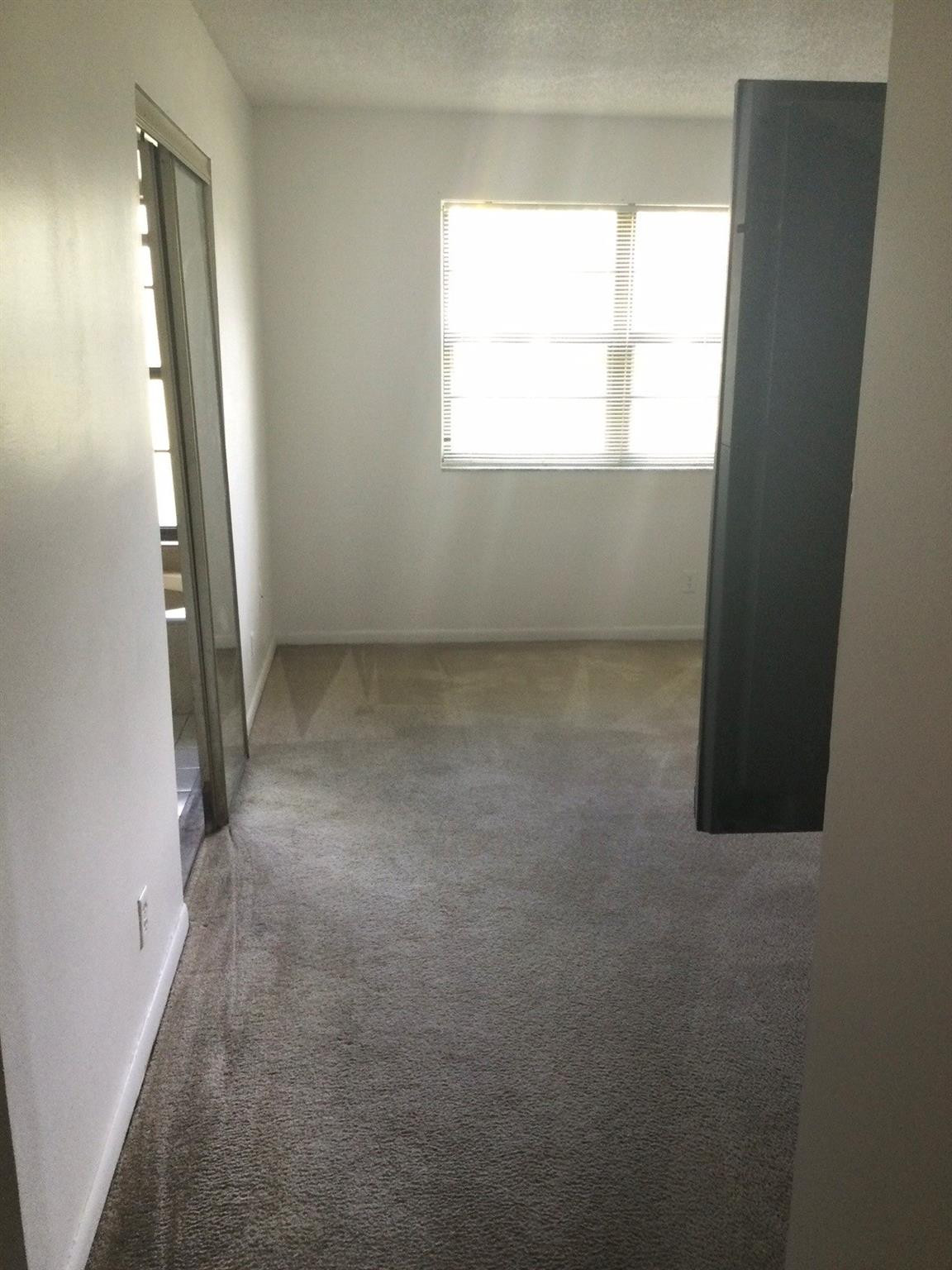9233 Southwest 8th Street, Unit 110 Boca Raton, FL 33428 - Photo 6 of 14 an empty room with a window