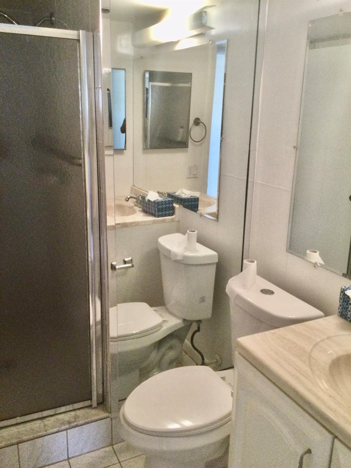 9233 Southwest 8th Street, Unit 110 Boca Raton, FL 33428 - Photo 7 of 14 a white toilet sitting next to a bathroom sink