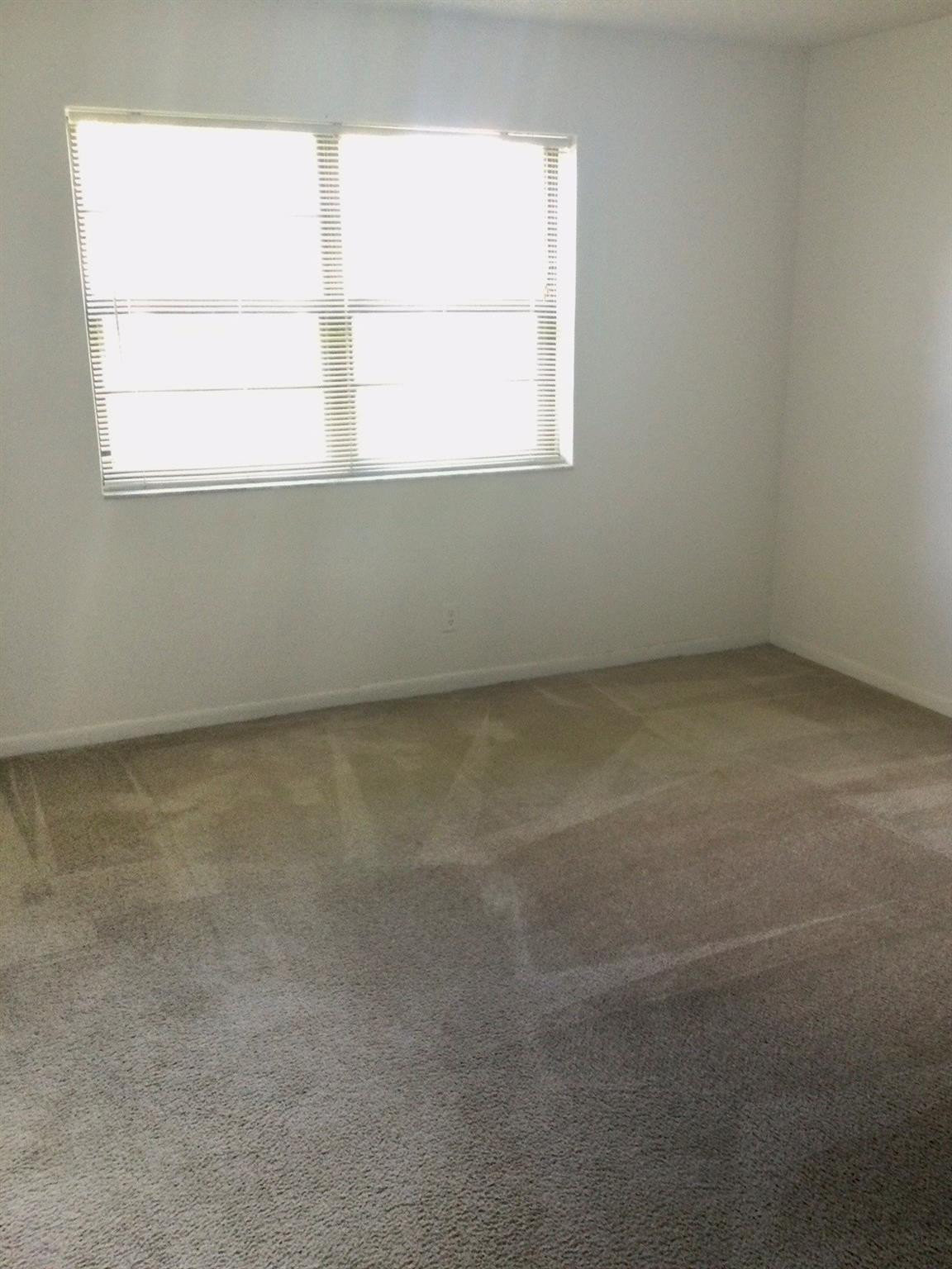 9233 Southwest 8th Street, Unit 110 Boca Raton, FL 33428 - Photo 9 of 14 an empty room with a window