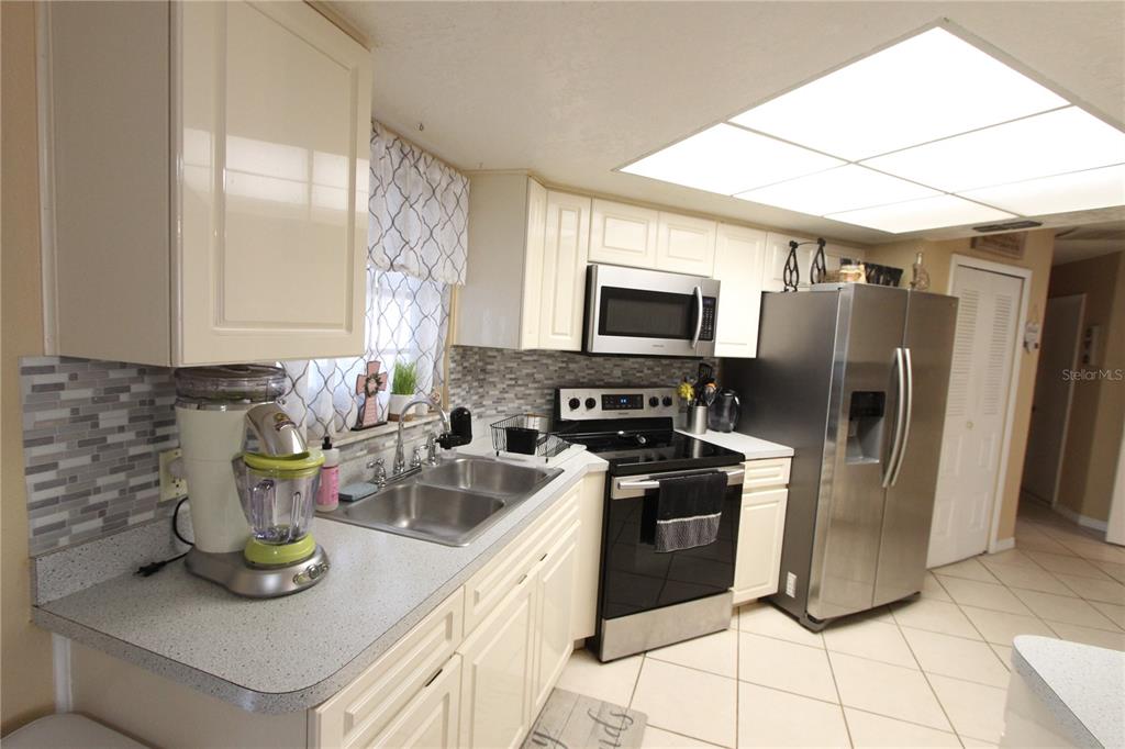 5046 Kenmore Street Spring Hill, FL 34608 - Photo 4 of 19 a kitchen with a refrigerator and a sink