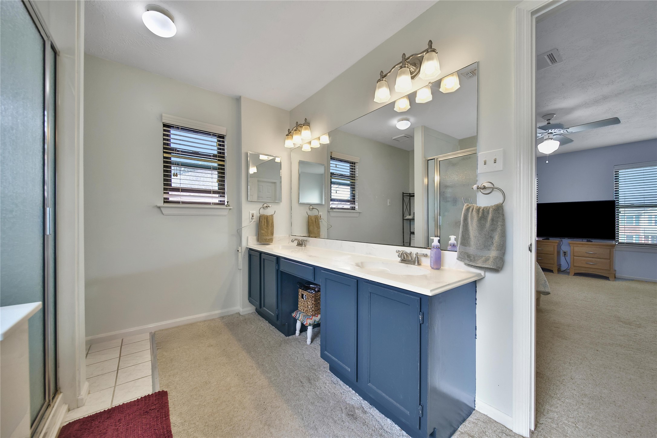 810 Noble Springs Road Houston, TX 77062 - Photo 17 of 27 a bathroom with a sink a large mirror and a shower