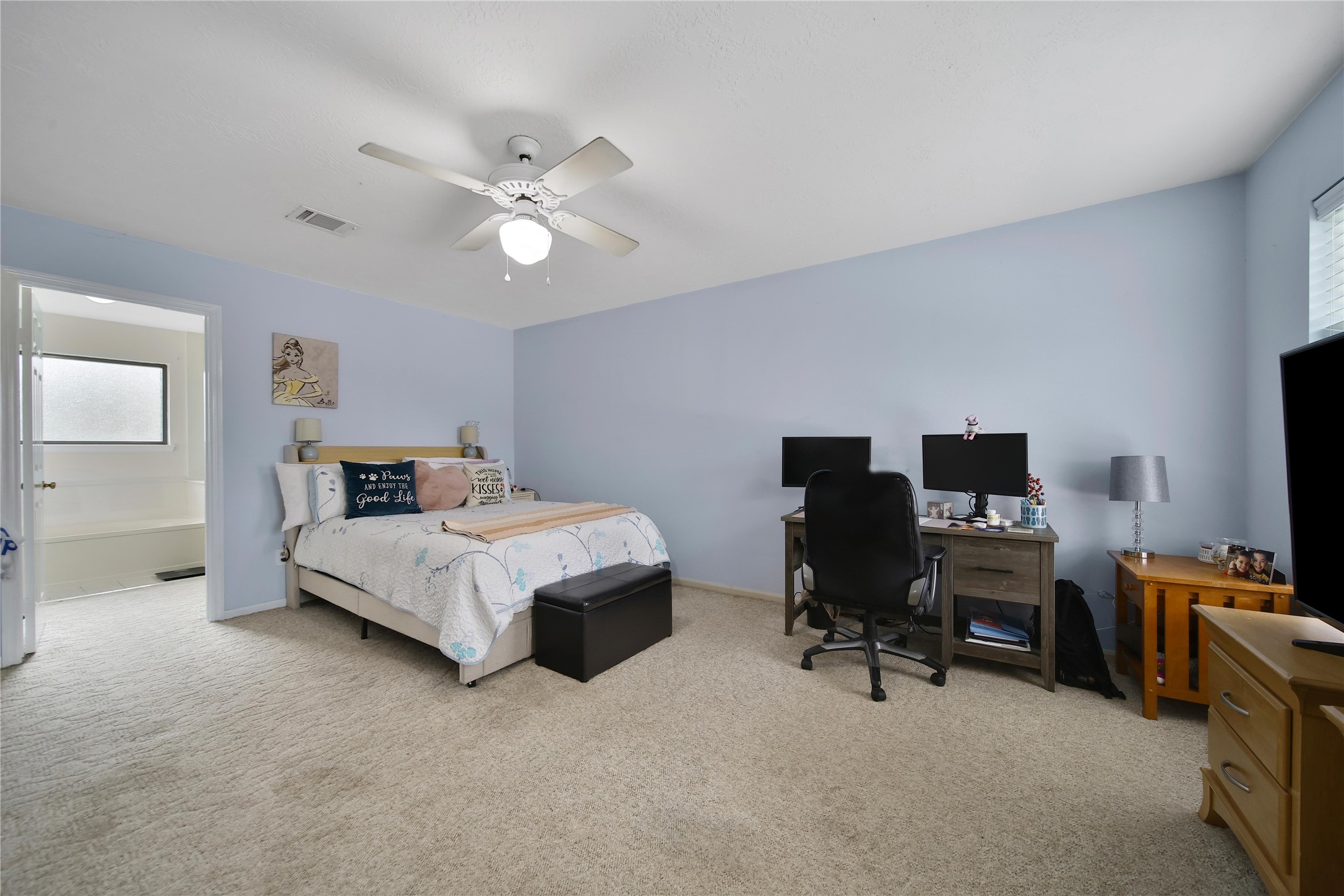 810 Noble Springs Road Houston, TX 77062 - Photo 19 of 27 a bedroom with a bed and a chandelier