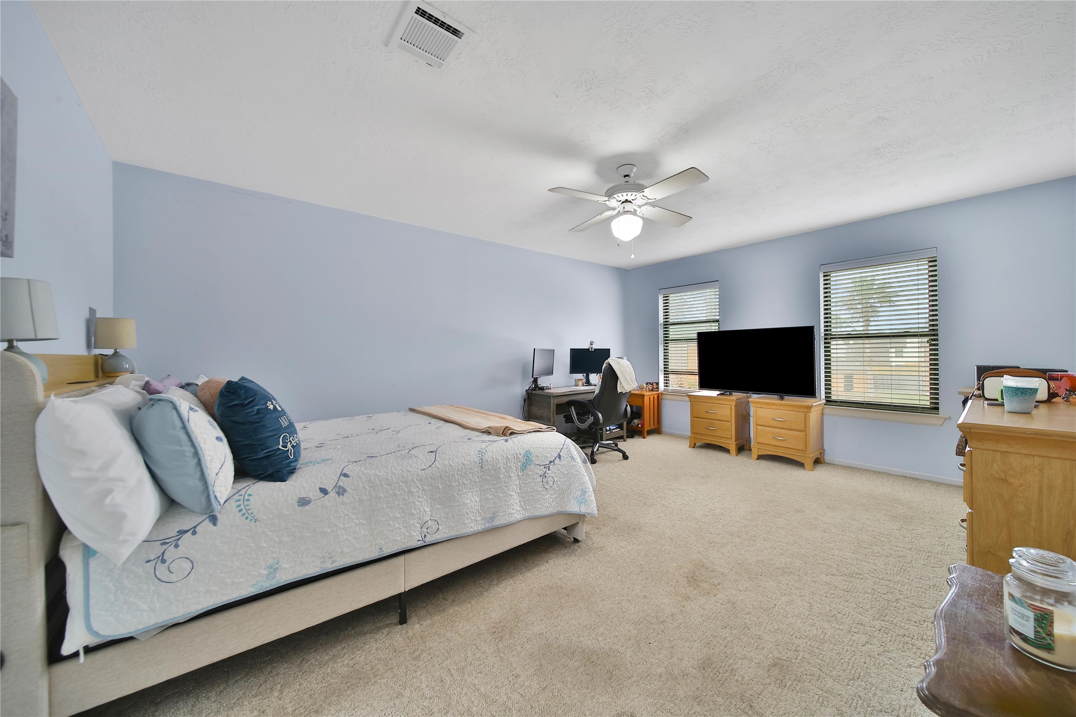810 Noble Springs Road Houston, TX 77062 - Photo 20 of 27 a spacious bedroom with a bed and a flat screen tv