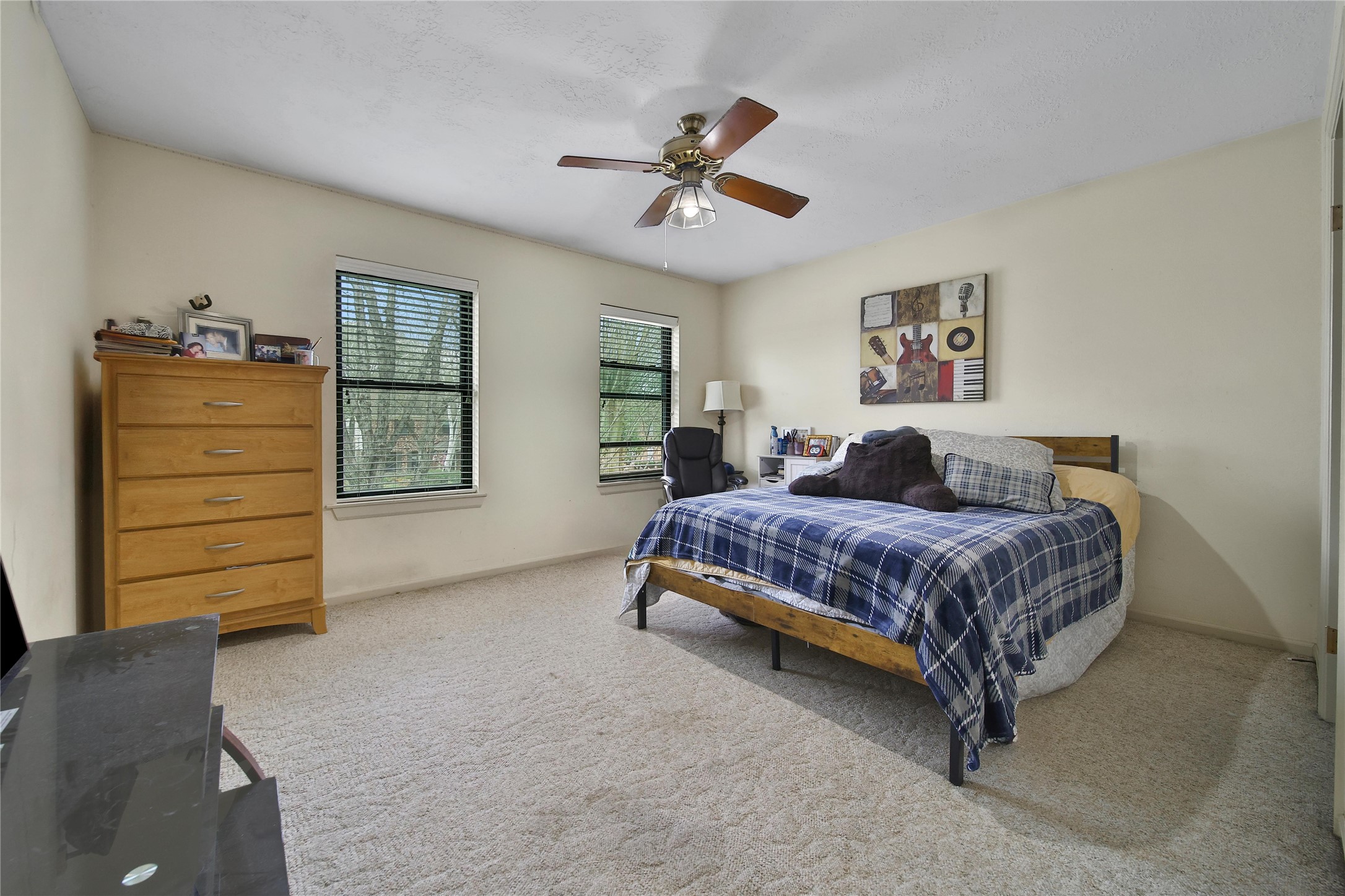 810 Noble Springs Road Houston, TX 77062 - Photo 22 of 27 a bedroom with a bed a dresser and a window