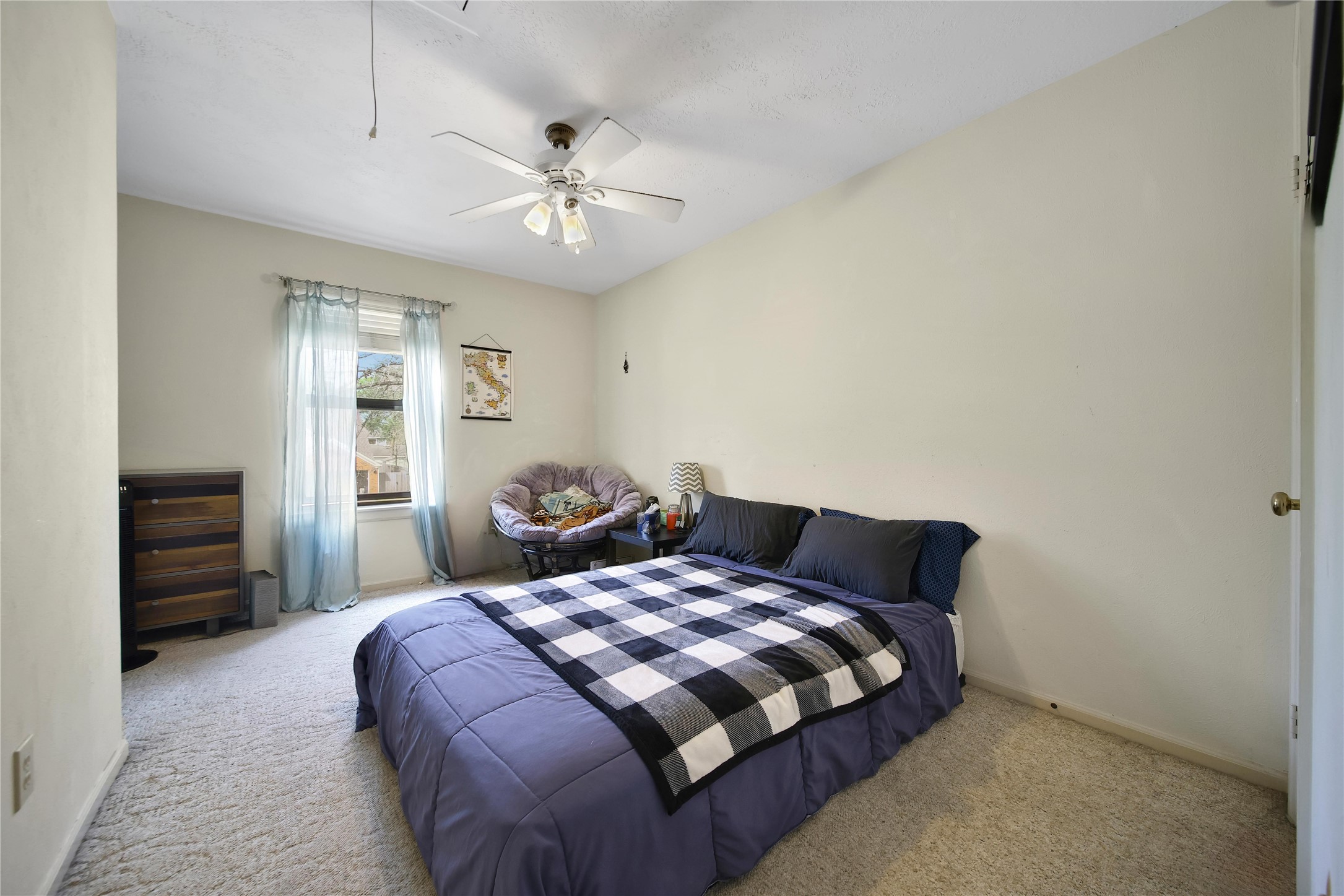 810 Noble Springs Road Houston, TX 77062 - Photo 24 of 27 a bedroom with a large bed and a chandelier