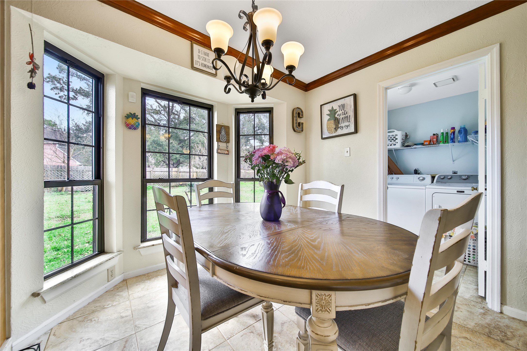 810 Noble Springs Road Houston, TX 77062 - Photo 5 of 27 a dining room with wooden floor a chandelier a wooden table and chairs