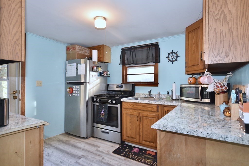 23 Trask Road Plymouth, MA 02360 - Photo 8 of 20 a kitchen with stainless steel appliances granite countertop a sink stove and refrigerator