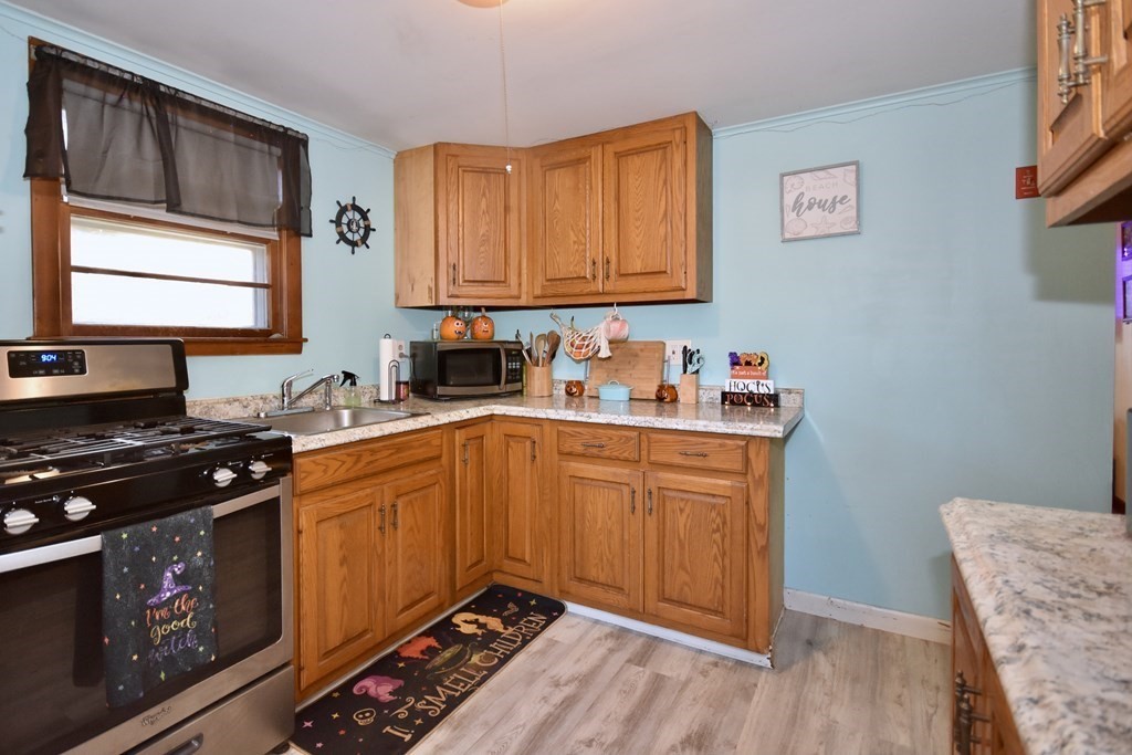 23 Trask Road Plymouth, MA 02360 - Photo 9 of 20 a kitchen with stainless steel appliances granite countertop a stove a sink dishwasher and cabinets with wooden floor