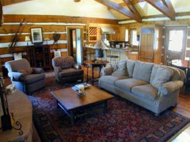 10 Arbaney Ranch Road, Unit INTEREST 1/4 Basalt, CO 81621 - Photo 3 of 3 a living room with furniture a rug and a large window