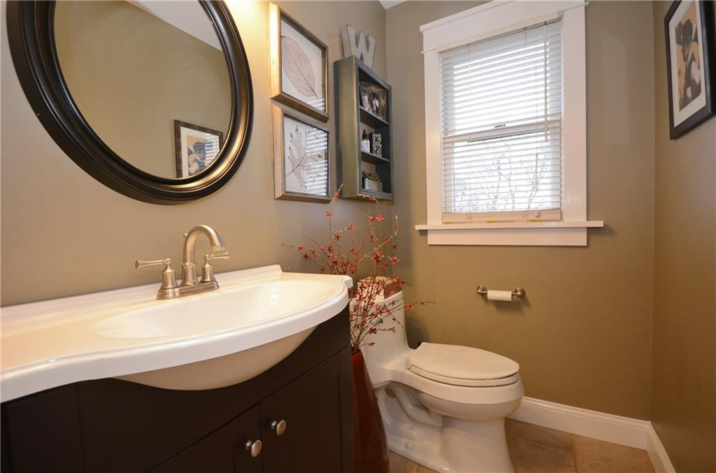 520 Fort Couch Road Pittsburgh, PA 15241 - Photo 5 of 25 a bathroom with a sink a mirror a toilet and a window