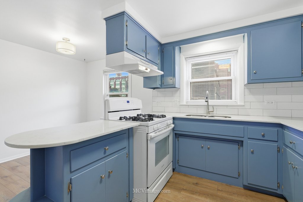 3840 South Wolcott Avenue, Unit 2 Chicago, IL 60609 - Photo 6 of 17 a kitchen with a stove cabinets and a sink