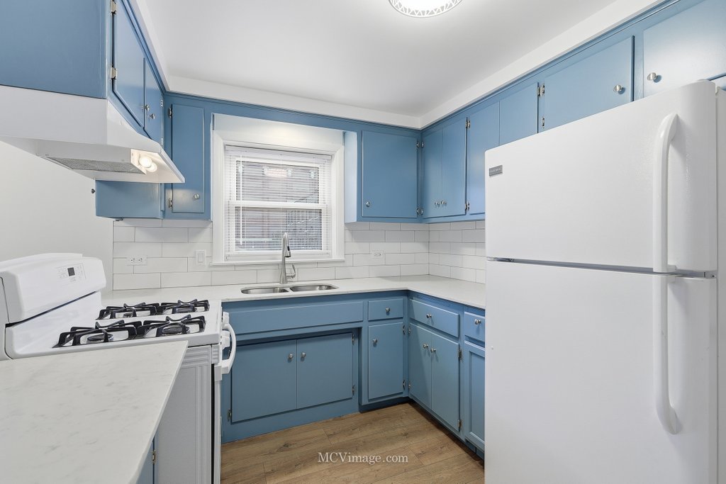 3840 South Wolcott Avenue, Unit 2 Chicago, IL 60609 - Photo 7 of 17 a kitchen with a sink a stove a refrigerator and cabinets