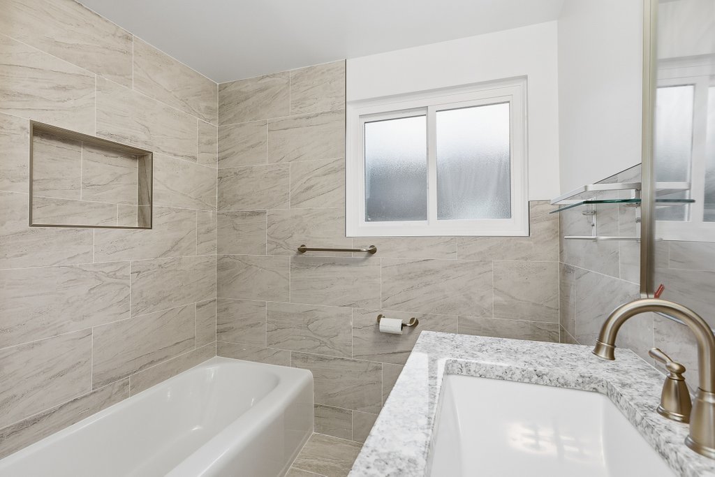 3840 South Wolcott Avenue, Unit 2 Chicago, IL 60609 - Photo 9 of 17 a bathroom with a tub sink and mirror