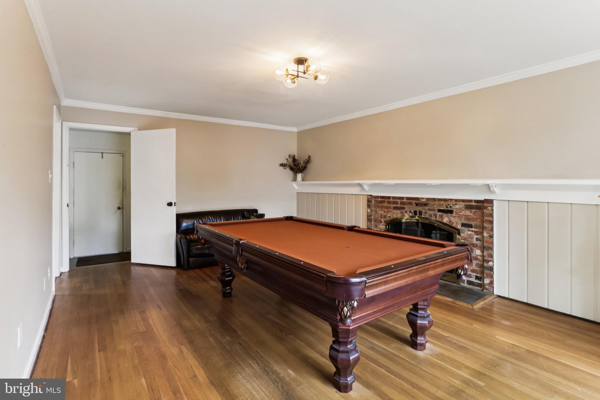 10233 Gainsborough Road Potomac, MD 20854 - Photo 19 of 50 a room with wooden floor and pool table