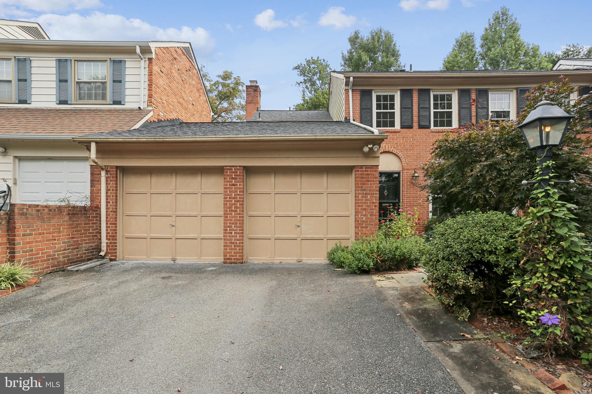 10233 Gainsborough Road Potomac, MD 20854 - Photo 2 of 50 a front view of a house with a yard and garage