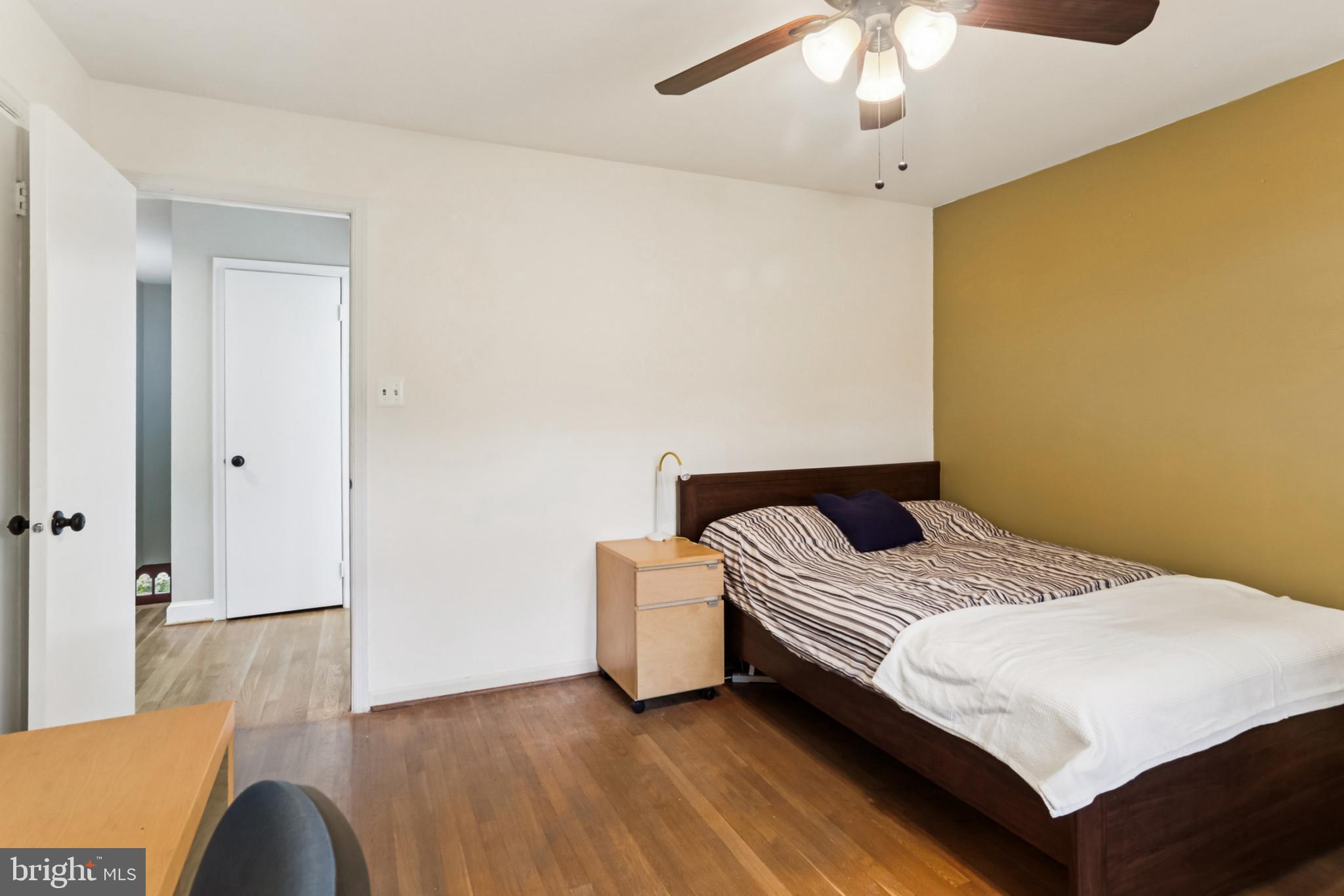 10233 Gainsborough Road Potomac, MD 20854 - Photo 26 of 50 a bedroom with a bed and a chandelier