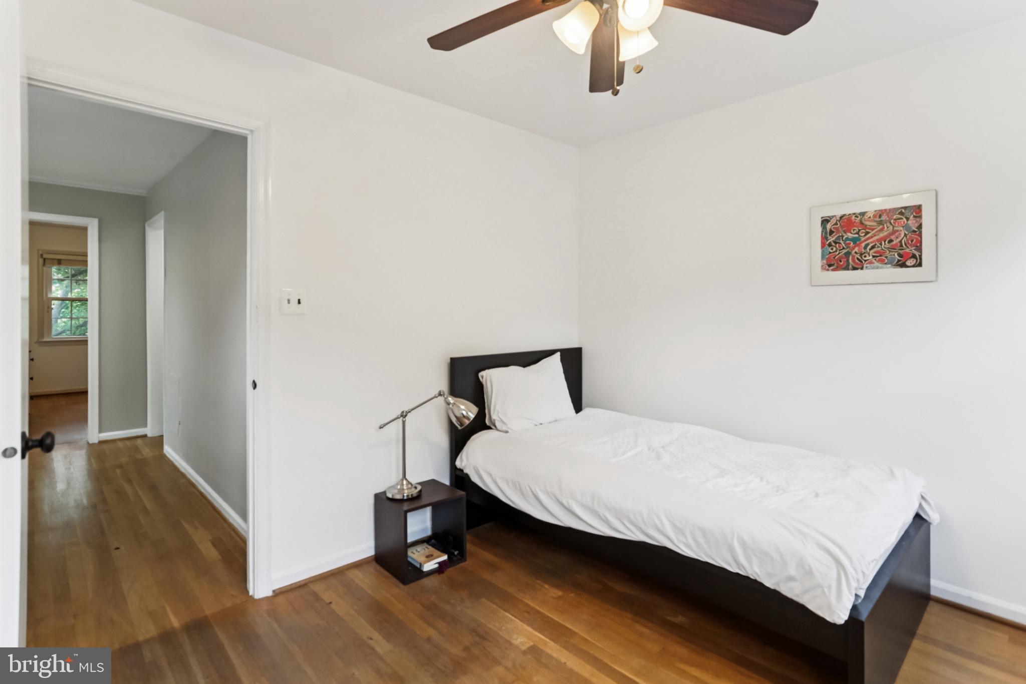 10233 Gainsborough Road Potomac, MD 20854 - Photo 27 of 50 a bedroom with a bed and a chandelier