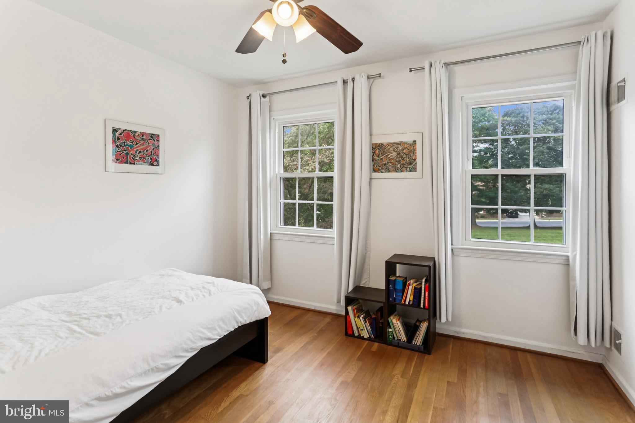 10233 Gainsborough Road Potomac, MD 20854 - Photo 28 of 50 a bedroom with a bed and wooden floor